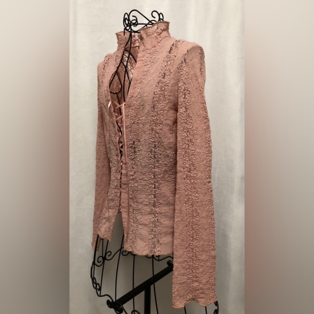 Light pink lace top with lace up front. Long sleeve.